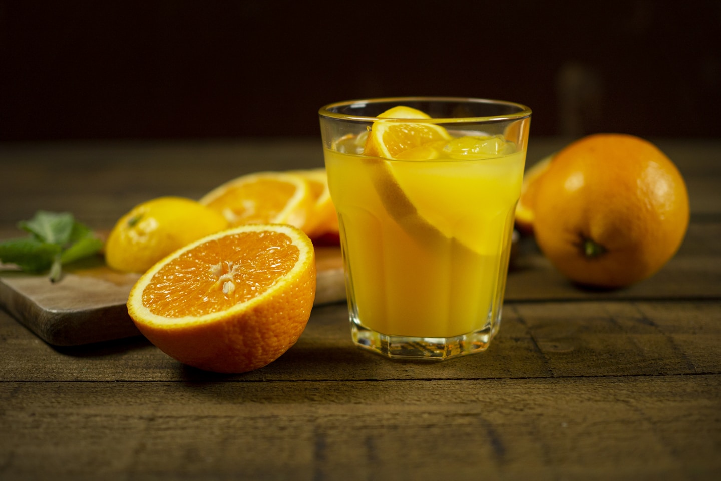 Orange juice surrounded by fruit